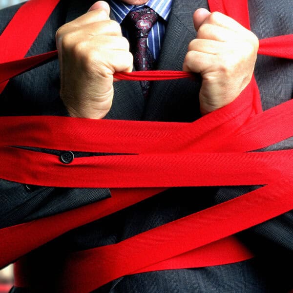 Image of Person tied up in red tape.